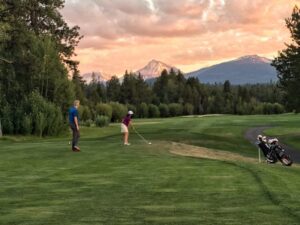 Golfer teeing off.