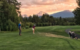 Golfer teeing off.