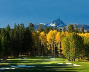Golf course, trees and mountain.
