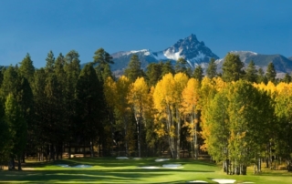 Golf course, trees and mountain.