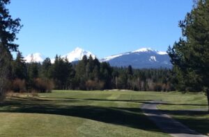 Golf course with mountain views.