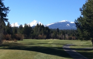 Golf course with mountain views.