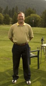 George Mack posing on green.