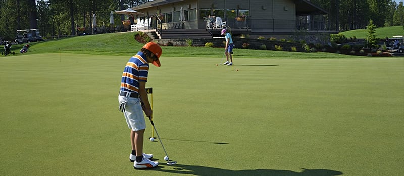 Young man putting.