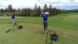 Golfer teeing off.