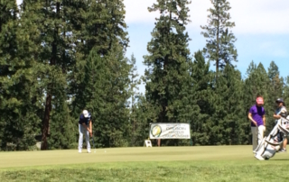 Golfer putting on green. Oregon Amateur Championship.