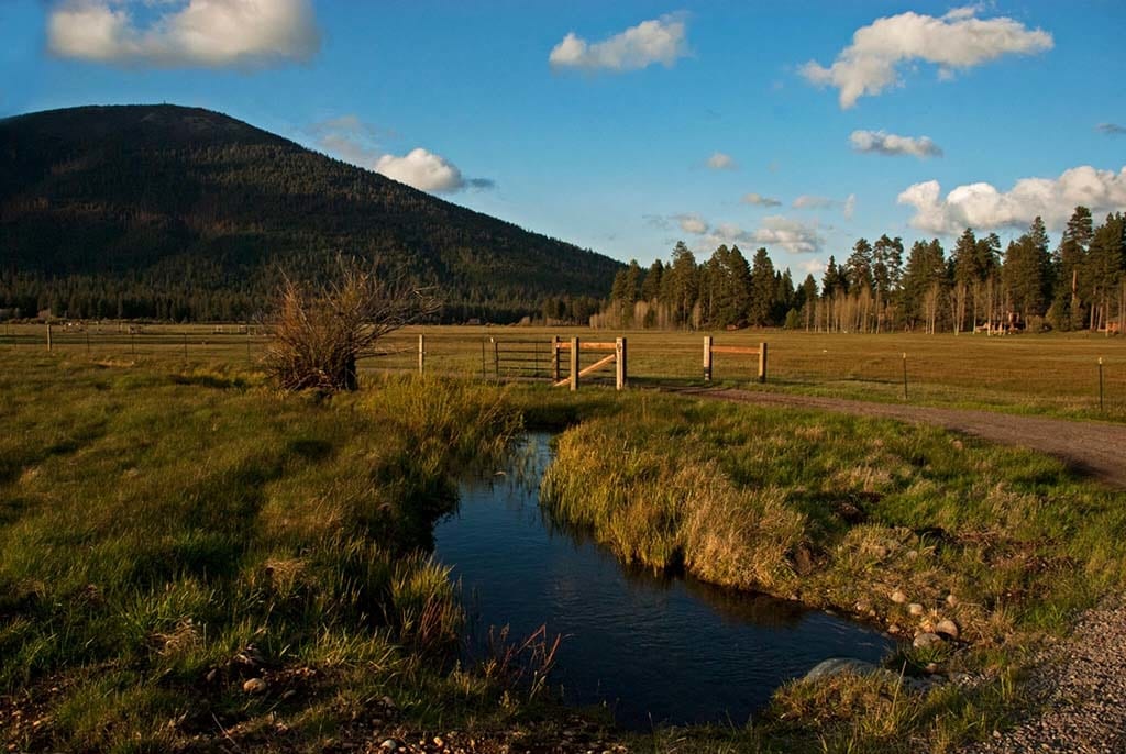 Creek and ranch fence in autumn.