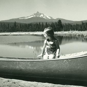 Black and white girl in a canoe.