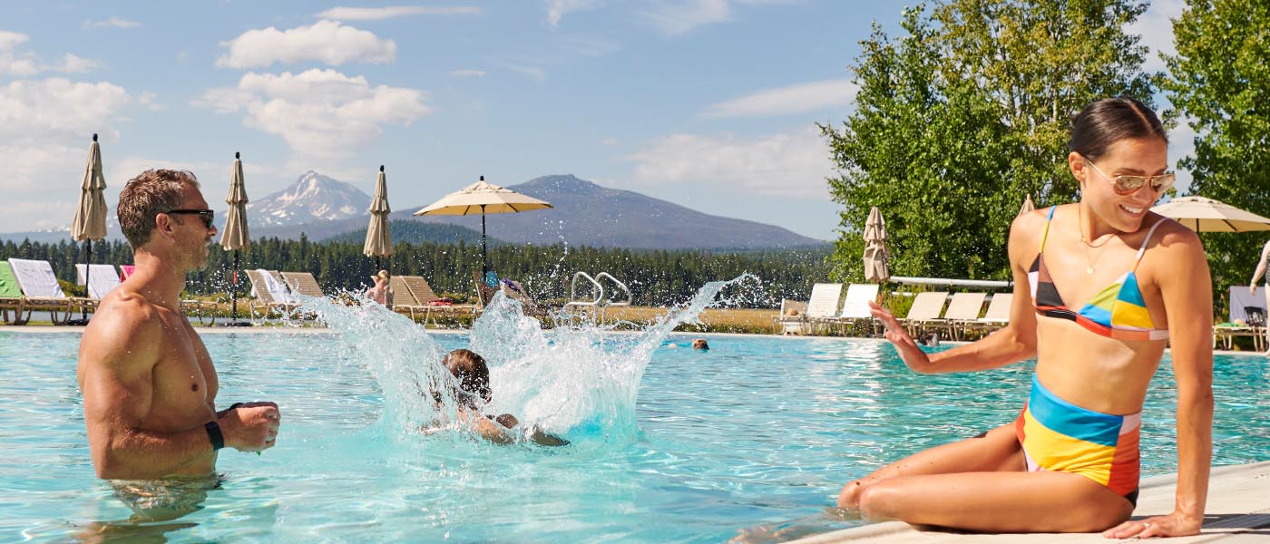 Family playing in the pool.