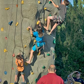 Kids on a climbing wall.