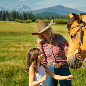 A girl petting a horse on her Oregon spring break.
