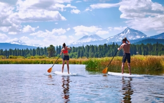 Two people paddleboarding, who found this idea after researching what to do in Sisters, Oregon.