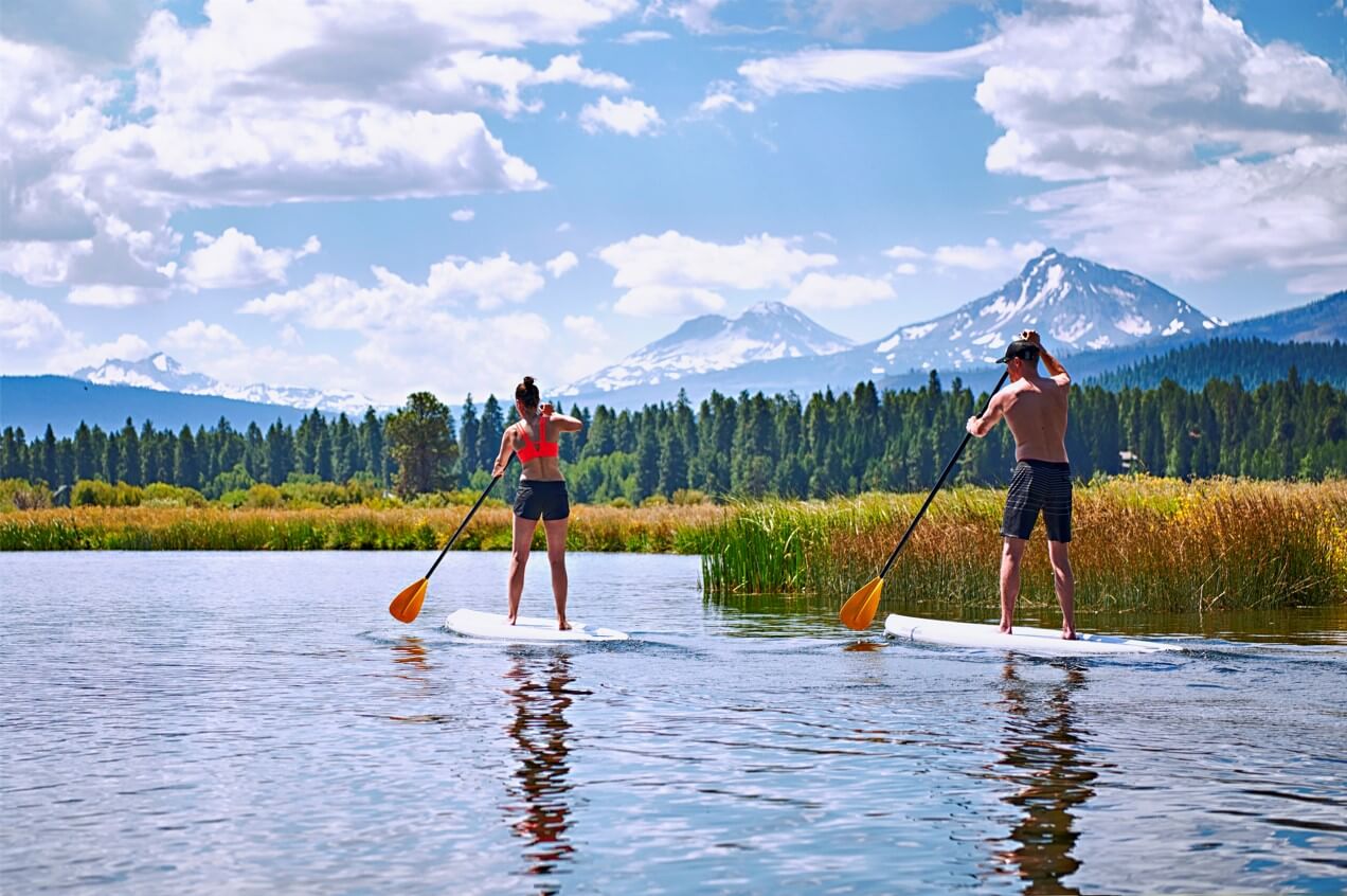 Two people paddleboarding, who found this idea after researching what to do in Sisters, Oregon.