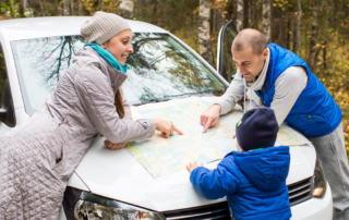 A family stopping to look at the map that's part of their Central Oregon trip planner.