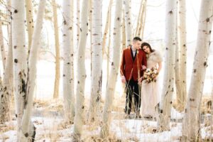 A couple taking photos during their winter Oregon wedding at Black Butte Ranch.