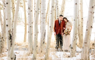 A couple taking photos during their winter Oregon wedding at Black Butte Ranch.
