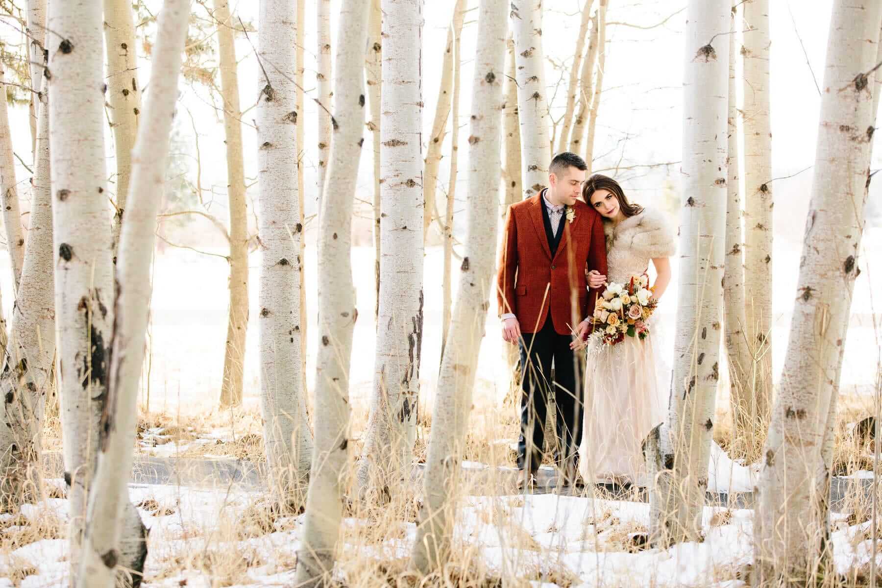 A couple taking photos during their winter Oregon wedding at Black Butte Ranch.