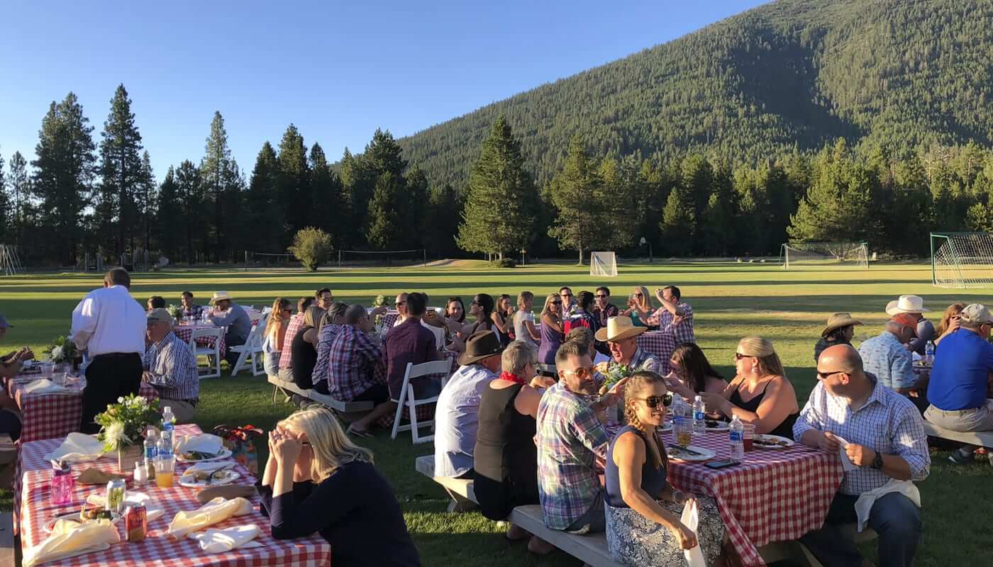 A large family sitting down for a meal, one of the top reunion ideas at BBR.