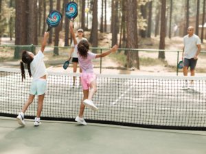 A family playing pickleball, one of the things to do at a resort in Sisters, Oregon.