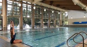 A woman at the indoor pool of a Sisters, Oregon, ranch due to dreary weather.