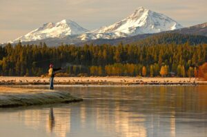A person fishing on their Bend to Sisters, Oregon, staycation.